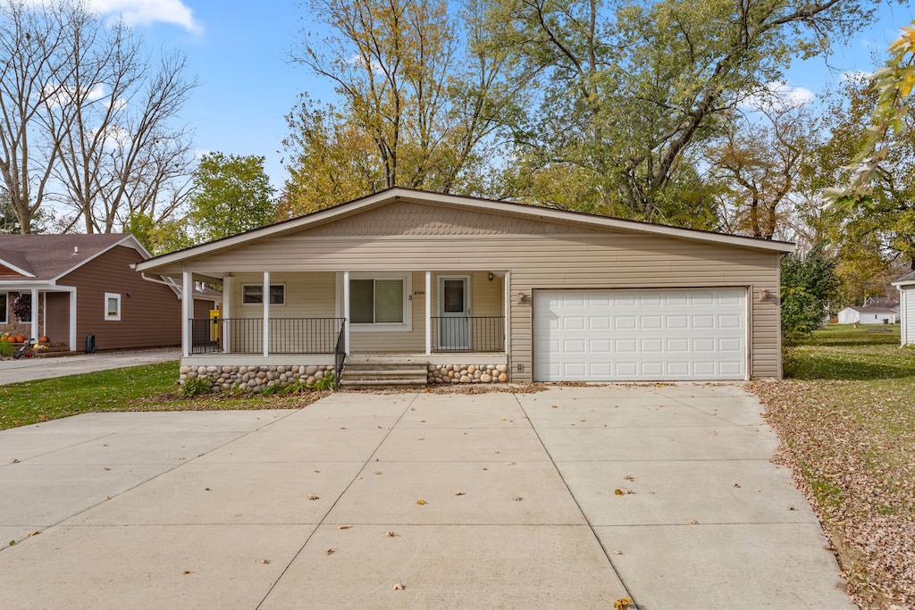 single story home with a porch and a garage