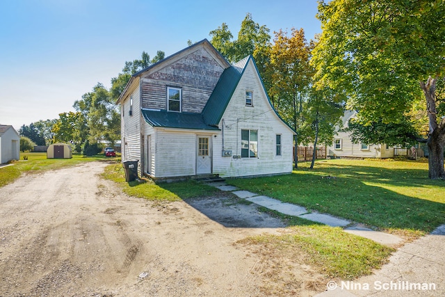 view of front of home featuring a shed and a front yard