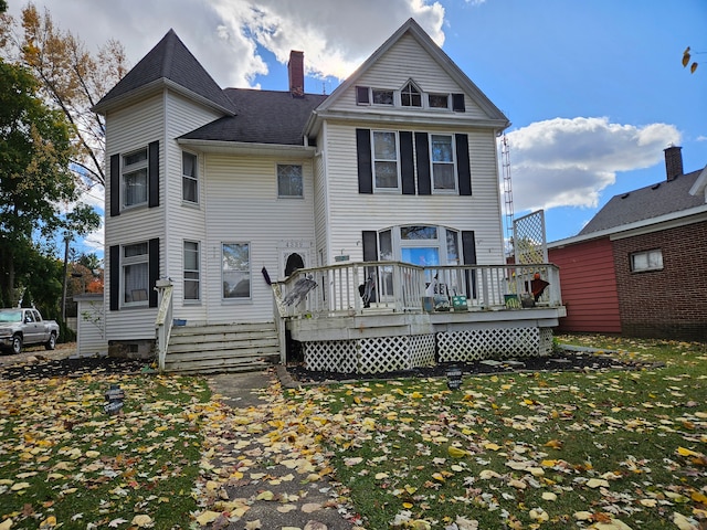 back of house with a deck