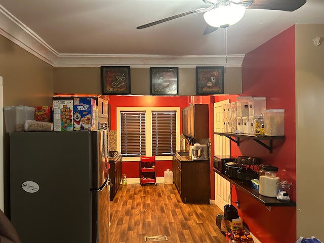 kitchen with stainless steel fridge, dark hardwood / wood-style flooring, ceiling fan, and ornamental molding