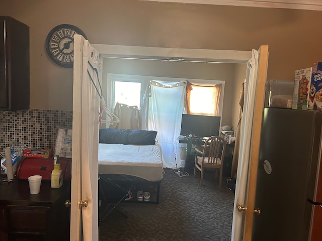 bedroom with stainless steel fridge