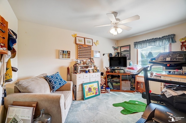 office space featuring light carpet and ceiling fan