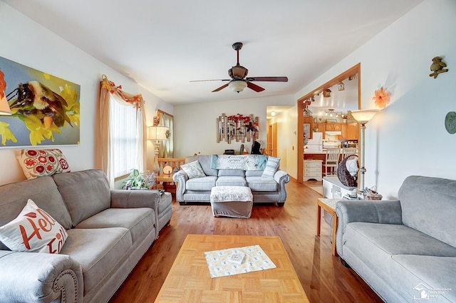 living room featuring hardwood / wood-style floors, ceiling fan, and lofted ceiling