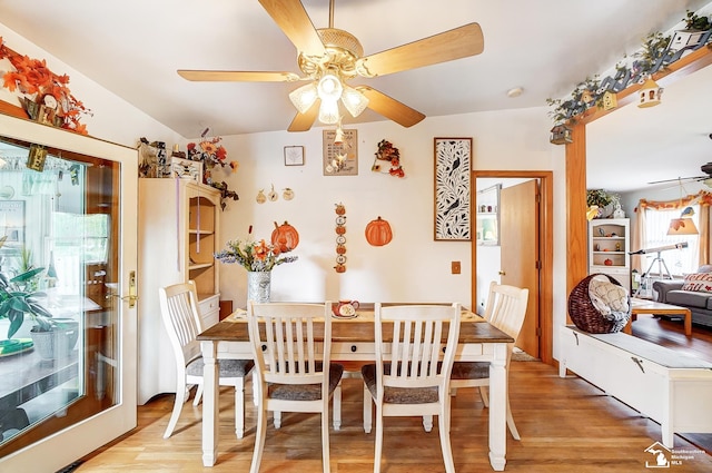 dining room with ceiling fan, light hardwood / wood-style floors, lofted ceiling, and a wealth of natural light