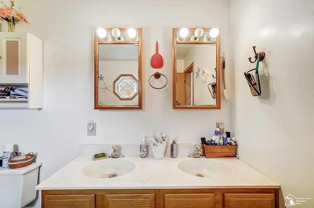 bathroom featuring vanity and toilet