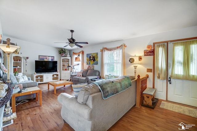 living room with light hardwood / wood-style flooring and ceiling fan