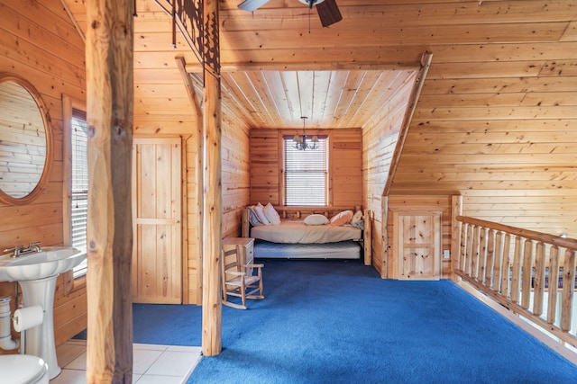 unfurnished bedroom featuring light tile patterned flooring, wood walls, ceiling fan, and wooden ceiling