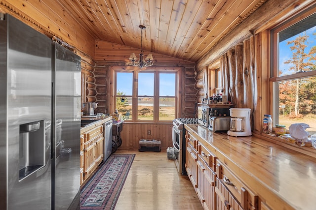 kitchen with vaulted ceiling, decorative light fixtures, light hardwood / wood-style floors, stainless steel appliances, and a chandelier