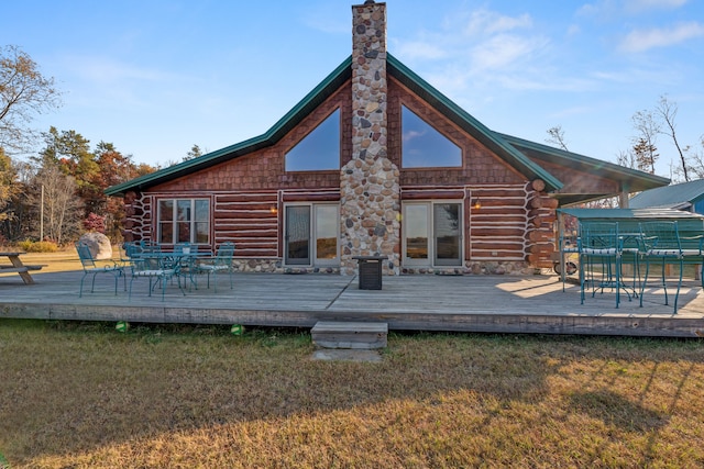 rear view of property with a deck and a lawn