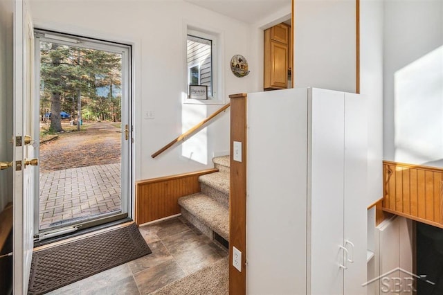 stairs featuring wood walls