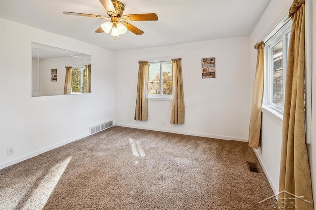 empty room with carpet flooring and ceiling fan