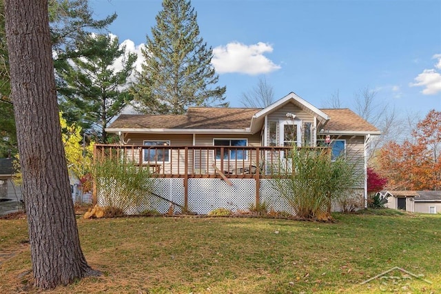 view of front of house with a wooden deck and a front yard