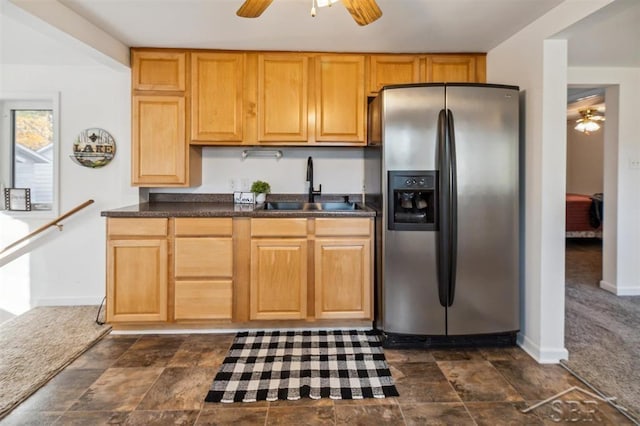 kitchen with dark colored carpet, stainless steel refrigerator with ice dispenser, and sink