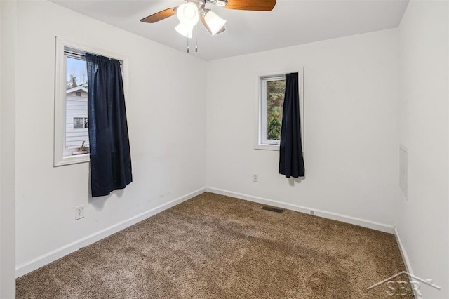 spare room with carpet floors and ceiling fan