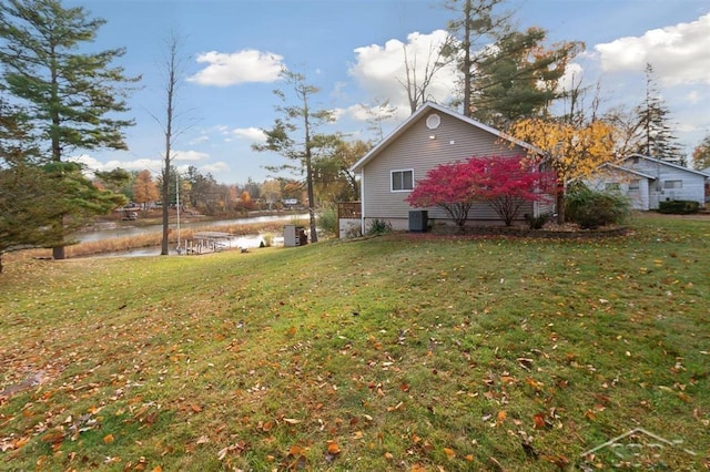 view of yard featuring a water view and central air condition unit