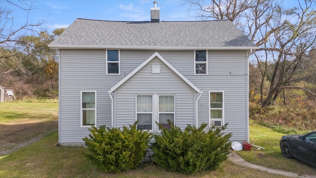 back of house featuring a lawn