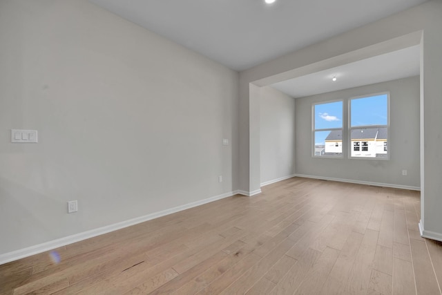 empty room with light hardwood / wood-style flooring