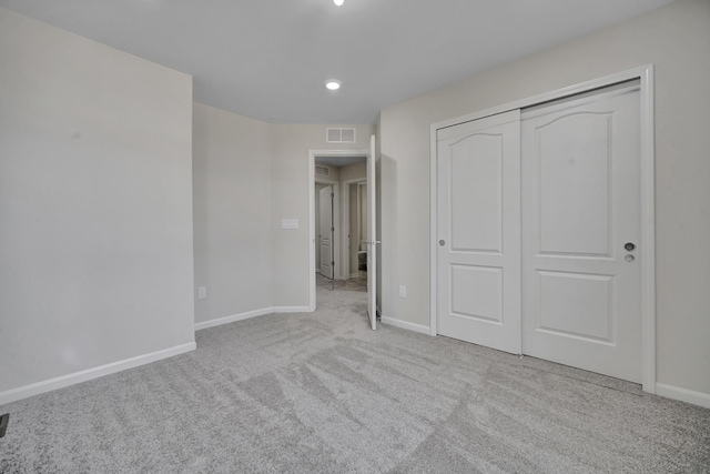 unfurnished bedroom with baseboards, recessed lighting, visible vents, a closet, and carpet floors