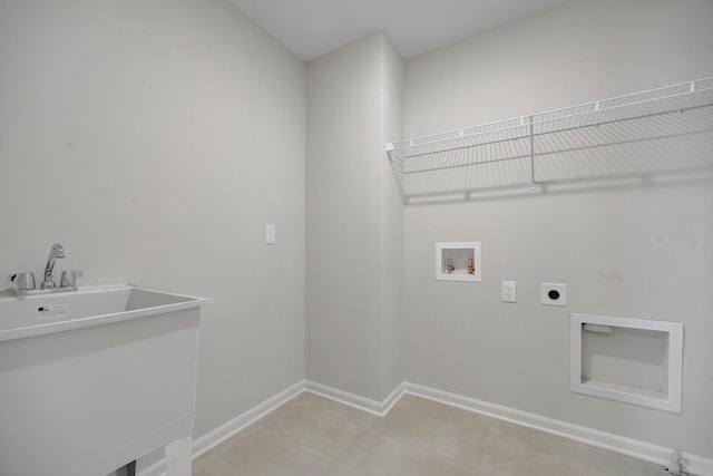 laundry area with laundry area, light tile patterned flooring, baseboards, electric dryer hookup, and washer hookup