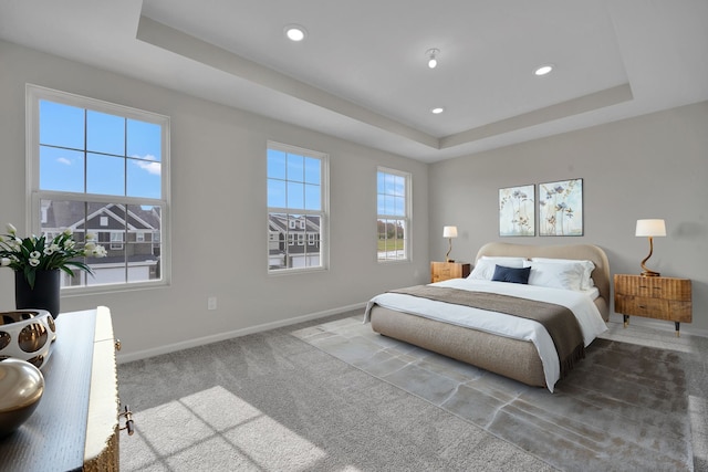 bedroom featuring recessed lighting, a raised ceiling, carpet flooring, and baseboards