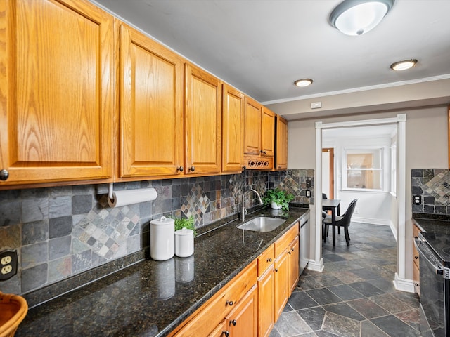 kitchen with decorative backsplash, appliances with stainless steel finishes, dark stone countertops, and sink