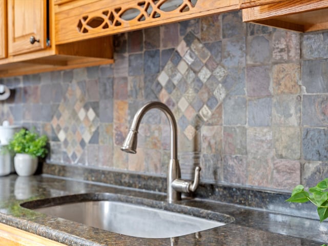 kitchen featuring decorative backsplash and sink