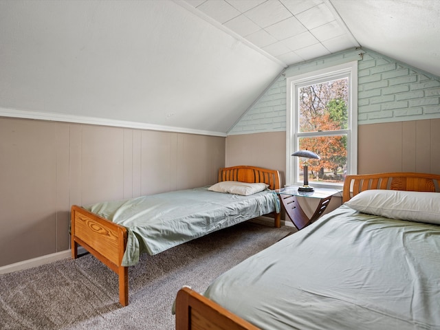 bedroom featuring lofted ceiling, carpet floors, and wooden walls