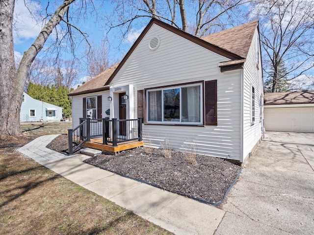 23096 Hawthorne St, Farmington, MI 48336 - bungalow-style home featuring a shingled roof, a detached garage, and an outdoor structure