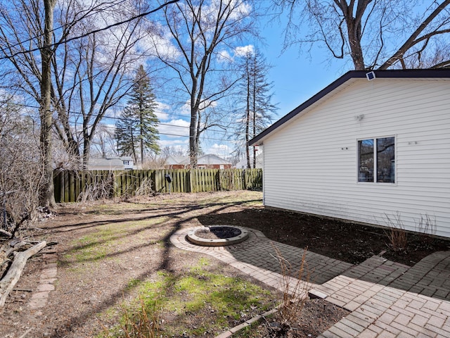 23096 Hawthorne St, Farmington, MI 48336 - view of home's exterior with a patio, a fire pit, and fence