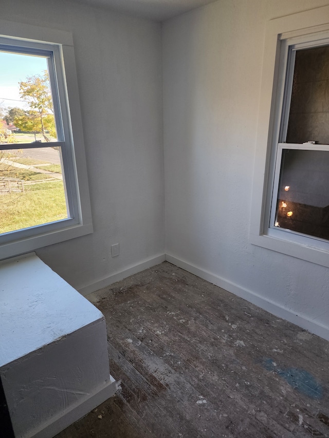 empty room with dark hardwood / wood-style flooring