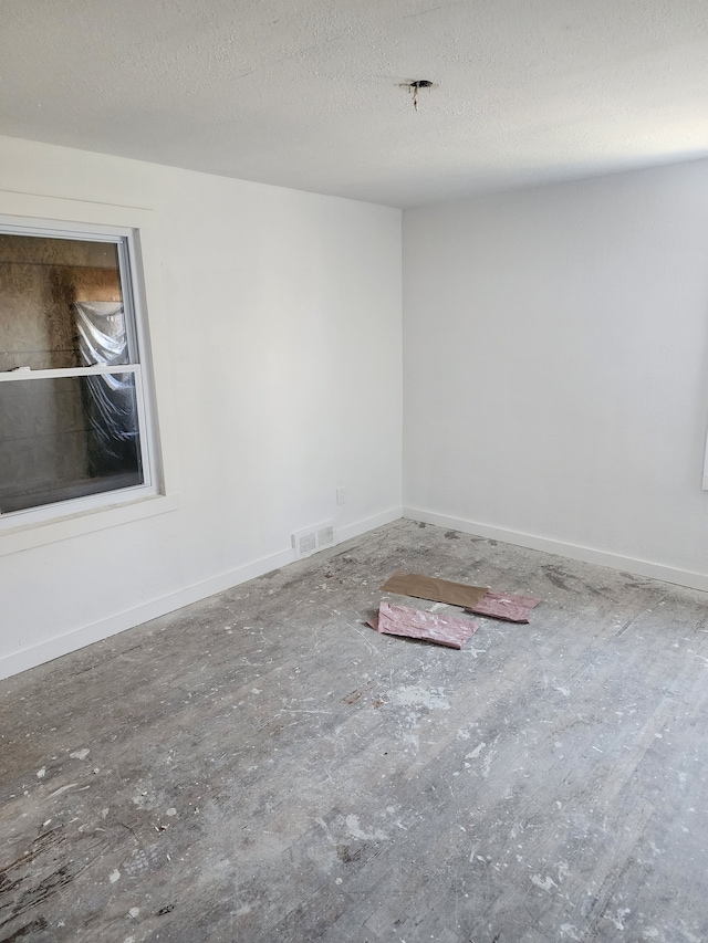 spare room featuring a textured ceiling