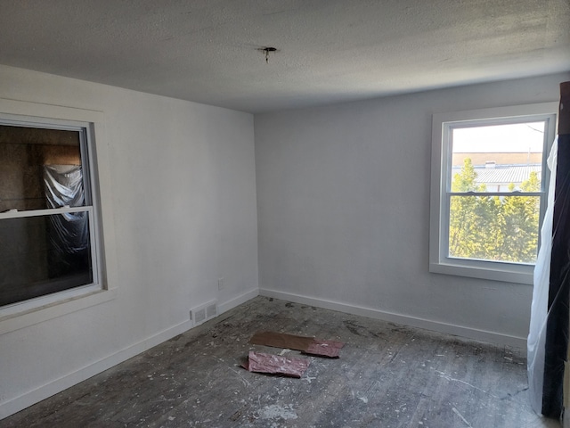 spare room featuring a textured ceiling