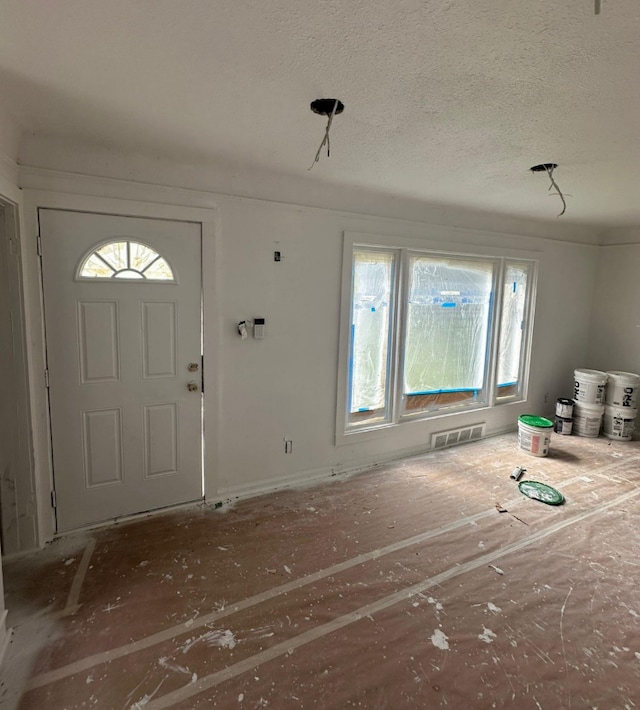 foyer featuring a textured ceiling