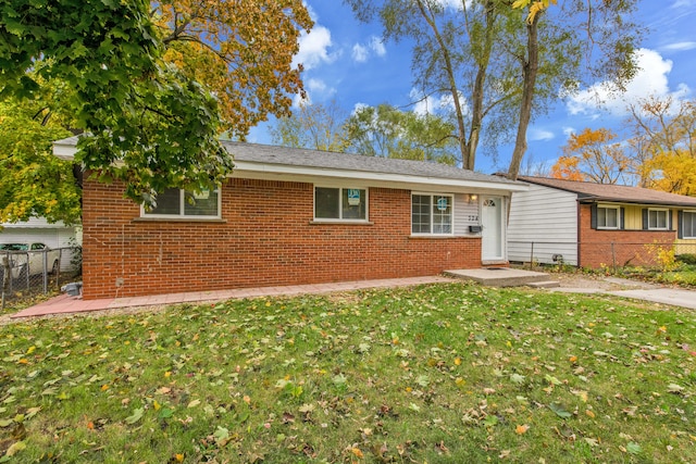 ranch-style home with a front lawn