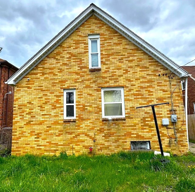 view of property exterior with a lawn