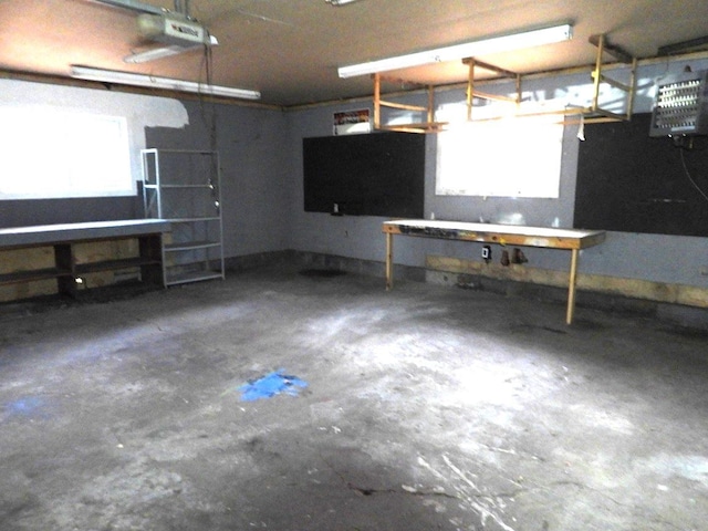 garage with a workshop area and a garage door opener