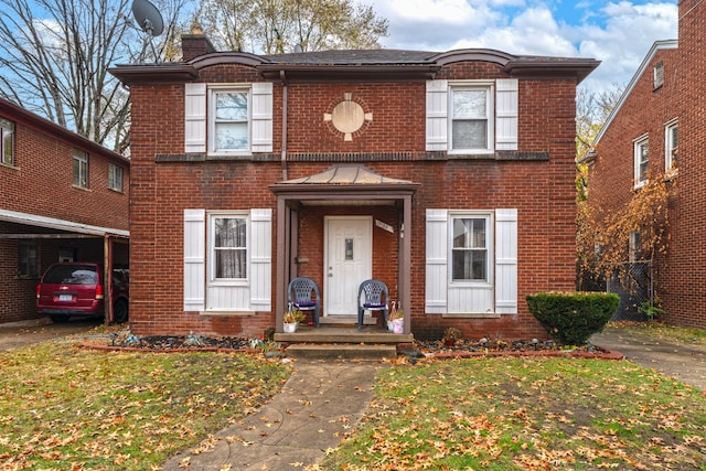 view of front of home with a front lawn and a carport