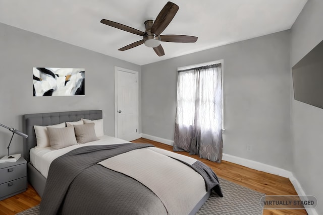 bedroom with ceiling fan and light hardwood / wood-style floors