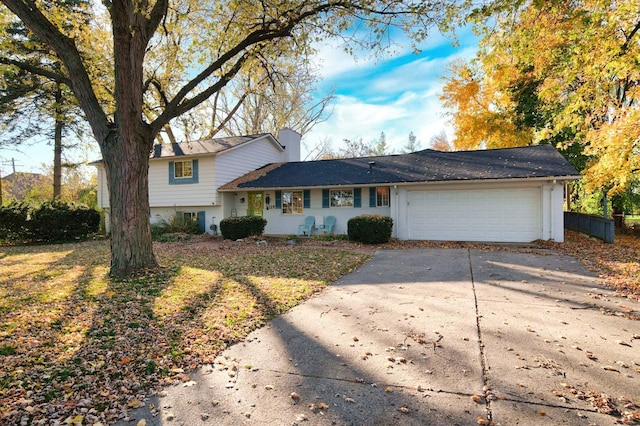 view of front of property featuring a garage and a front lawn