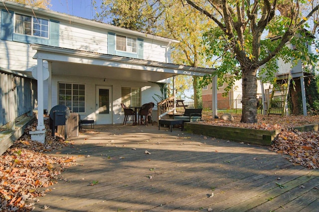 rear view of house featuring a deck