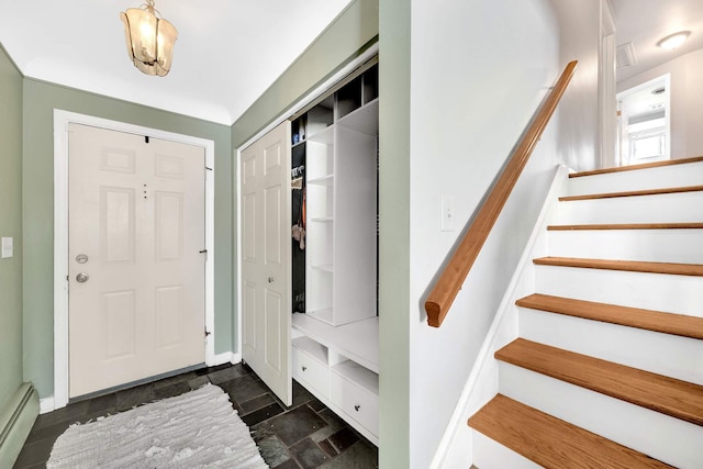 foyer entrance with a baseboard heating unit