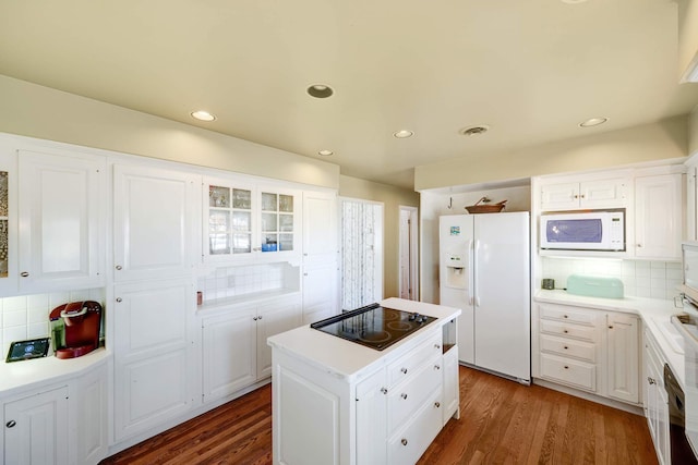 kitchen with white cabinets, white appliances, and dark wood-type flooring