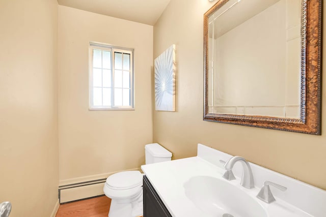 bathroom featuring hardwood / wood-style flooring, toilet, vanity, and a baseboard heating unit