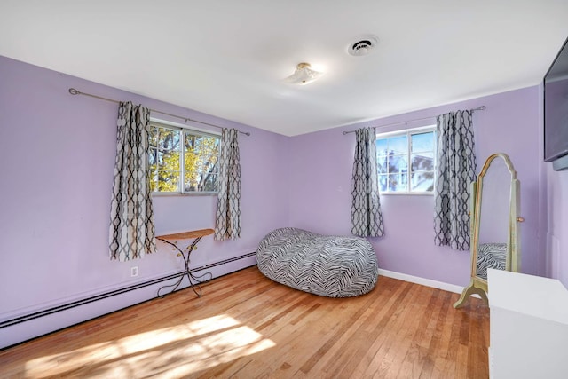 interior space with hardwood / wood-style floors and a baseboard radiator