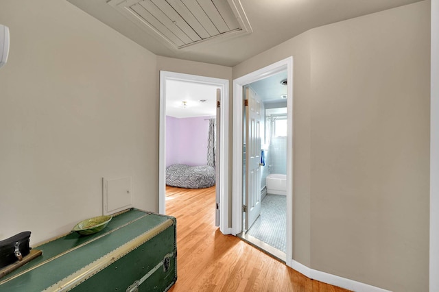 corridor with hardwood / wood-style flooring