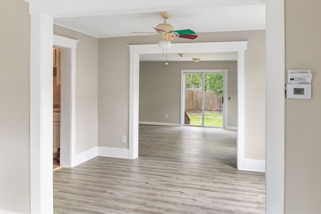 unfurnished room featuring light wood-type flooring and ceiling fan