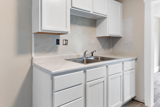 kitchen featuring white cabinetry and sink