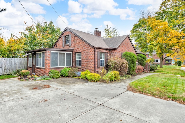 view of side of property with a lawn