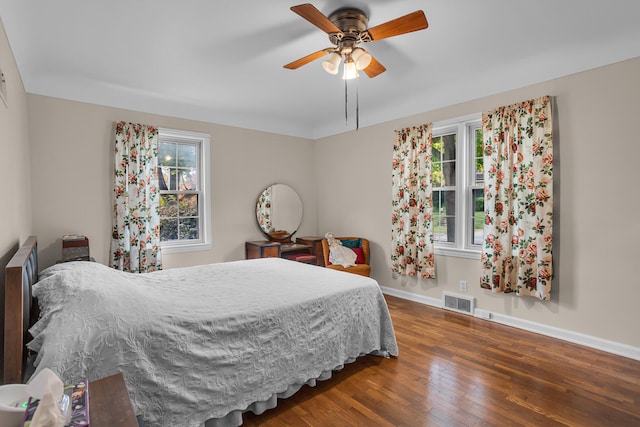 bedroom with ceiling fan and dark wood-type flooring