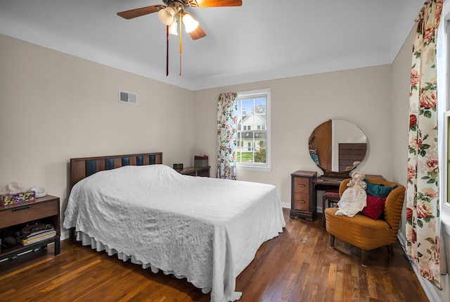 bedroom with ceiling fan and dark hardwood / wood-style floors